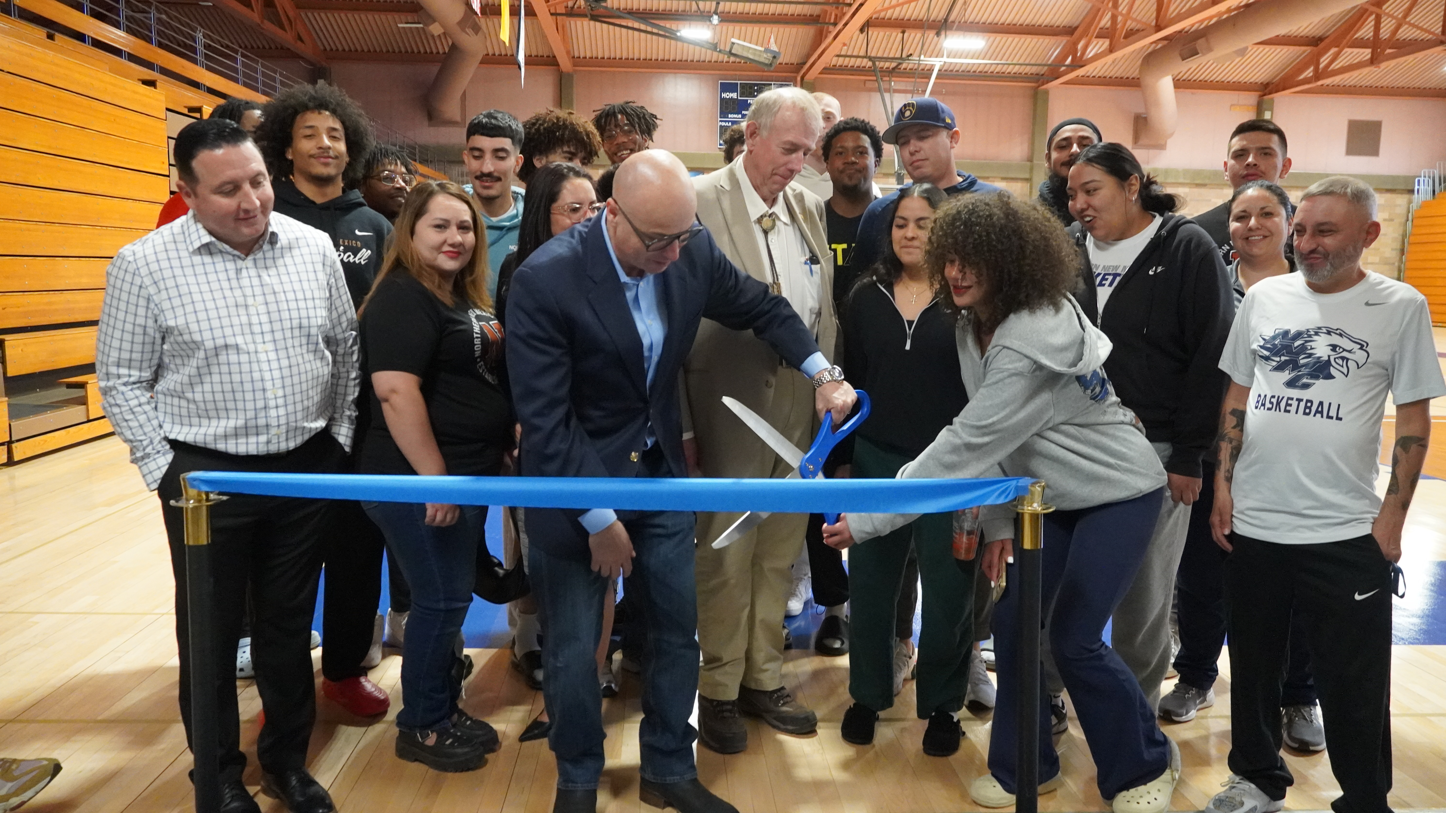 Student-athletes, faculty, staff, Board of Regents members cutting the ribbon for Northern New Mexico College’s newly renovated Gym and the Fit Lab